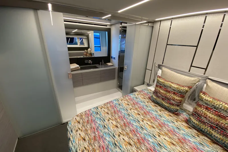  Yacht Photos Pics Luxurious 2023 Pershing 6X yacht bedroom with modern design and colorful bedding.