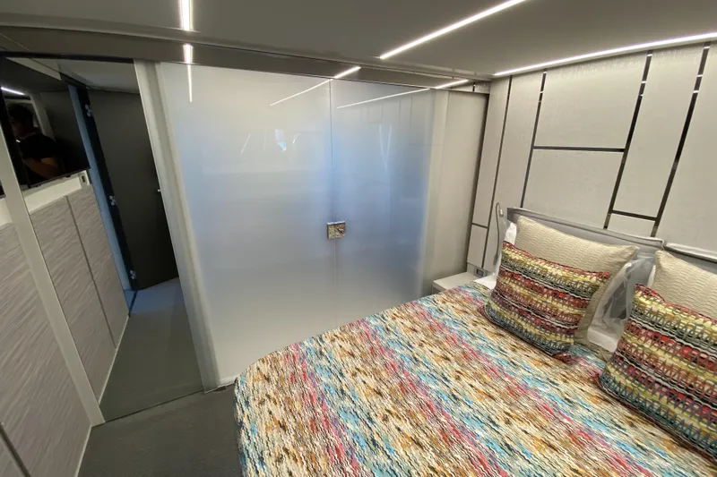  Yacht Photos Pics Luxurious 2023 Pershing 6X yacht interior with modern bedroom design and colorful bedding.