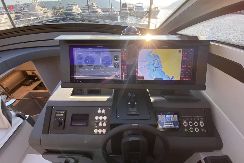  Yacht Photos Pics 2023 Pershing 6X yacht helm with advanced navigation displays and controls.