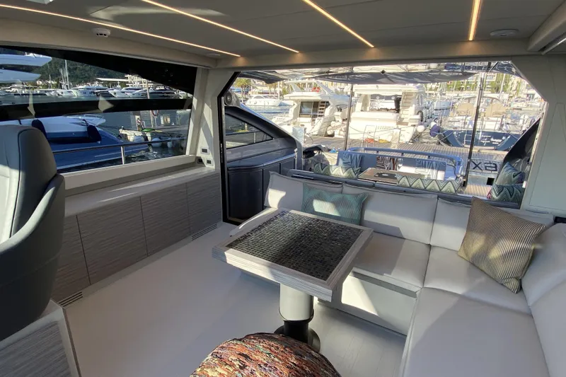  Yacht Photos Pics Luxurious interior of 2023 Pershing 6X yacht with modern seating and marina view.