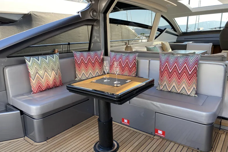  Yacht Photos Pics Luxurious 2023 Pershing 6X yacht interior with stylish seating and colorful zigzag pillows.