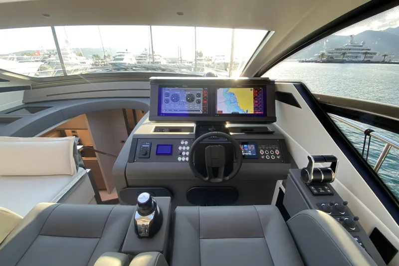  Yacht Photos Pics 2023 Pershing 6X yacht cockpit with advanced navigation systems and luxurious seating.