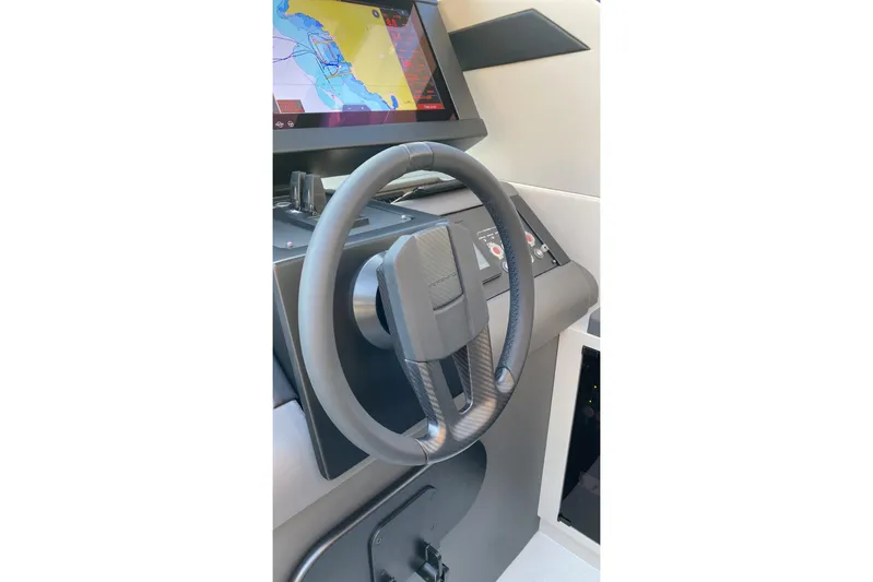  Yacht Photos Pics 2023 Pershing 6X yacht helm with modern steering wheel and navigation display.