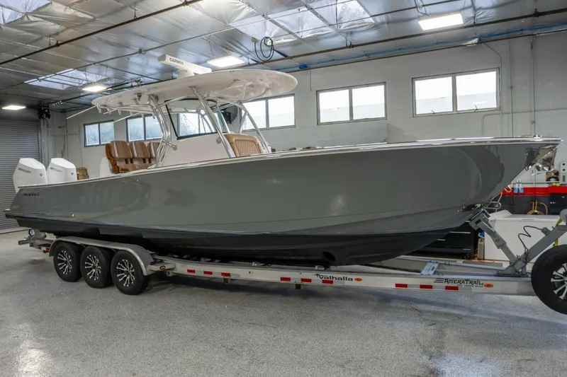 T/t Silvertime Yacht Photos Pics 2023 Valhalla Boatworks V-33 on trailer in indoor showroom.