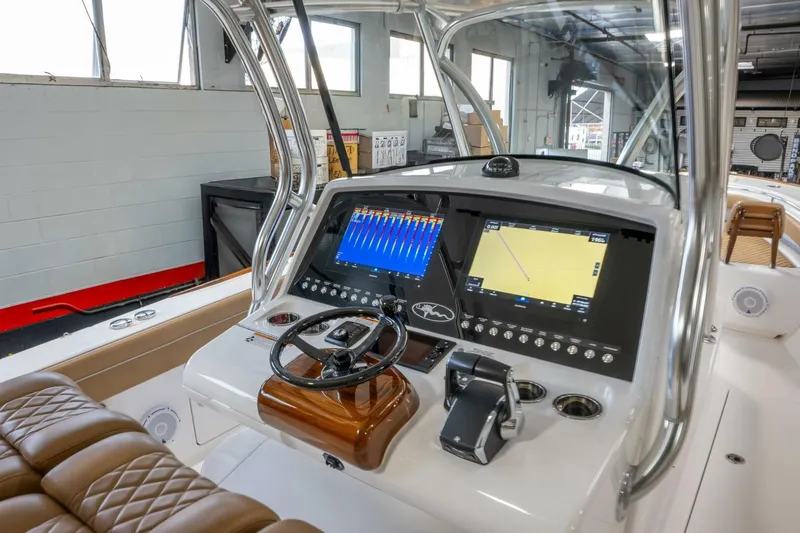 T/t Silvertime Yacht Photos Pics 2023 Valhalla Boatworks V-33 helm with advanced navigation displays and luxurious seating.