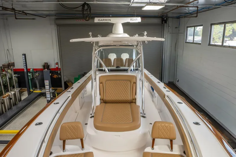 T/t Silvertime Yacht Photos Pics 2023 Valhalla Boatworks V-33 interior with tan seating in a garage setting.