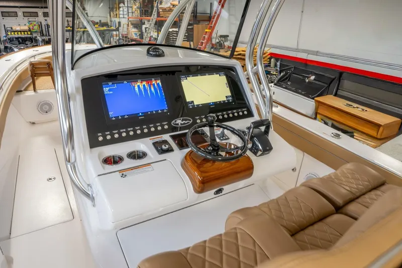 T/t Silvertime Yacht Photos Pics 2023 Valhalla Boatworks V-33 helm with dual displays and luxurious seating.