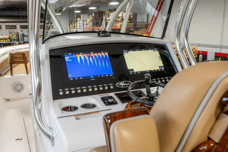 T/t Silvertime Yacht Photos Pics 2023 Valhalla Boatworks V-33 helm with advanced navigation displays and controls.