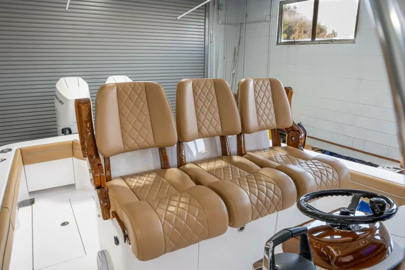 T/t Silvertime Yacht Photos Pics 2023 Valhalla Boatworks V-33 interior with luxurious tan leather seating and modern steering wheel.