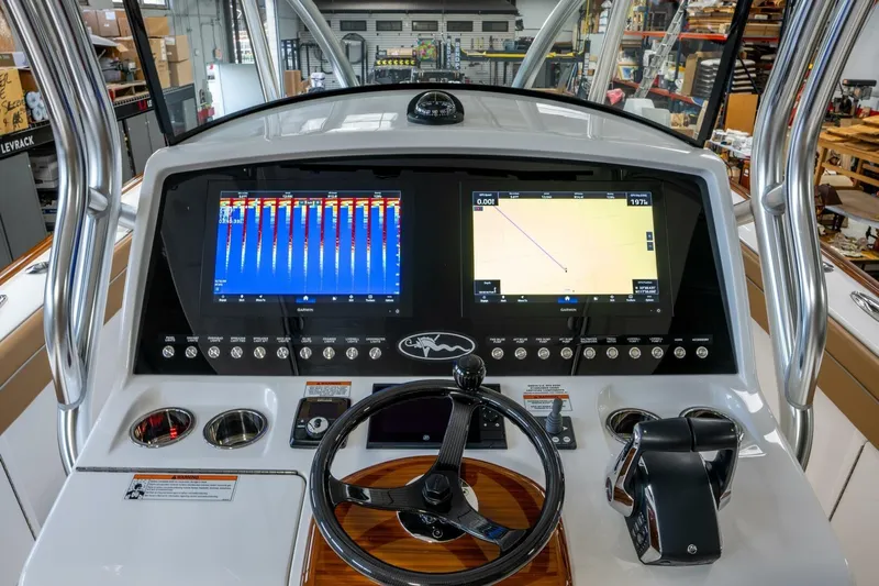 T/t Silvertime Yacht Photos Pics 2023 Valhalla Boatworks V-33 helm with advanced navigation displays and controls.