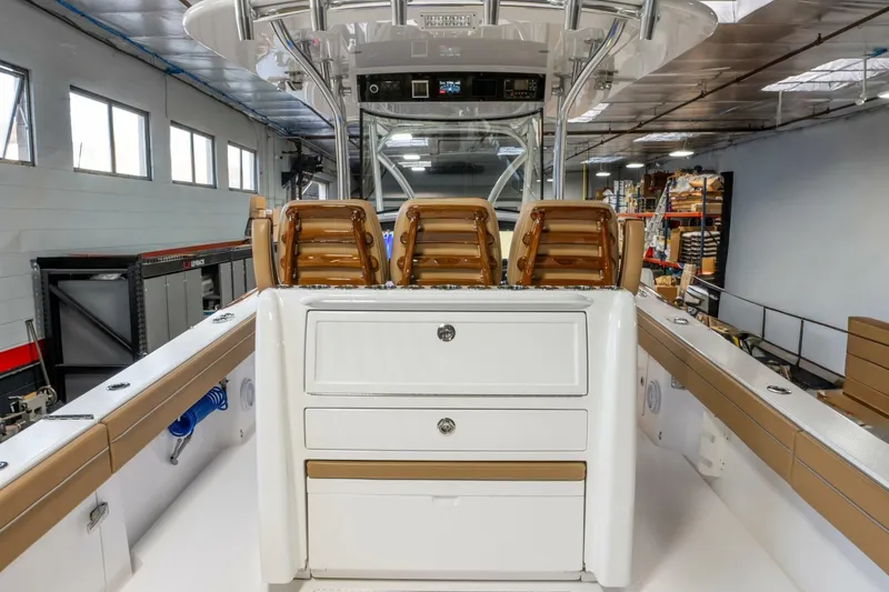 T/t Silvertime Yacht Photos Pics 2023 Valhalla Boatworks V-33 interior with seating and storage in a workshop setting.