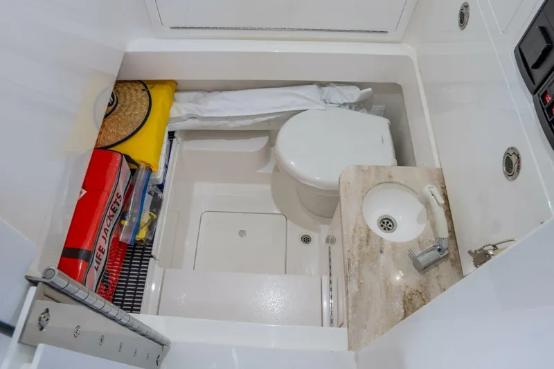 T/t Silvertime Yacht Photos Pics 2023 Valhalla V-33 boat interior with toilet, sink, and life jackets.