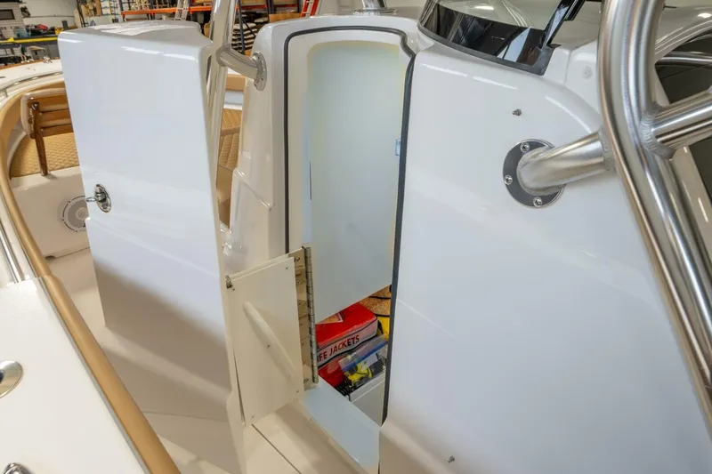 T/t Silvertime Yacht Photos Pics 2023 Valhalla Boatworks V-33 interior storage compartment with life jackets visible.