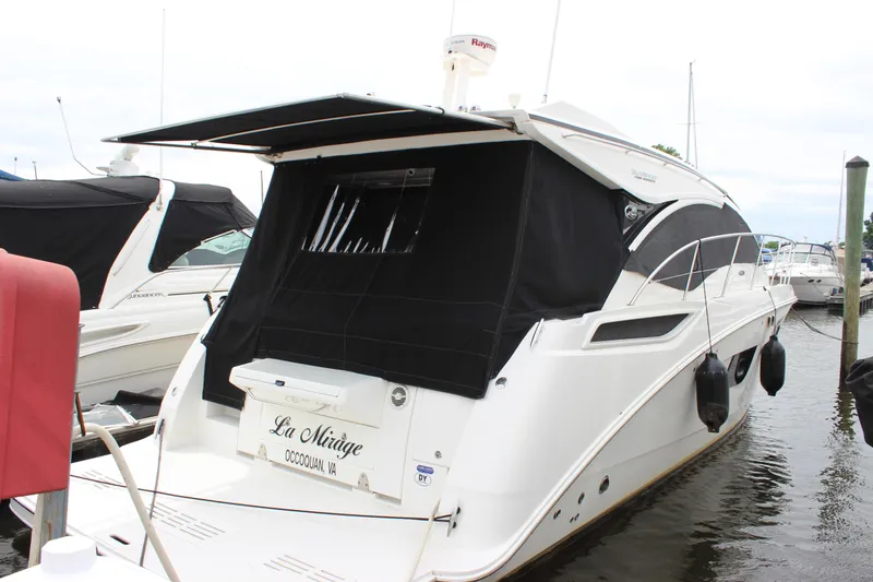  Yacht Photos Pics 2017 Sea Ray Sundancer 400 yacht docked with black canopy and sleek design.