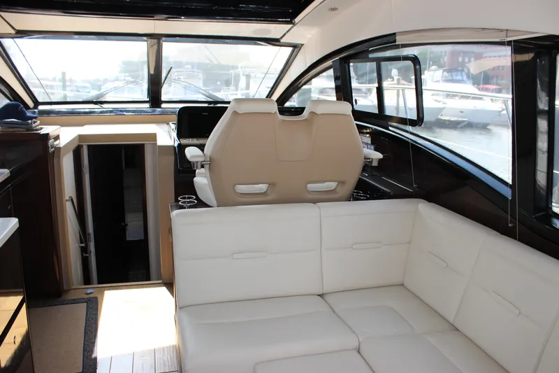  Yacht Photos Pics Interior of 2017 Sea Ray Sundancer 400 yacht with white seating and helm station.