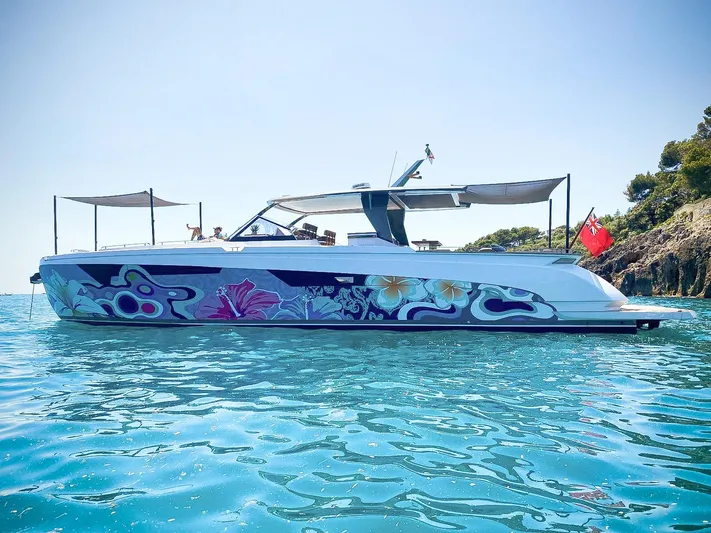 Mia Yacht Photos Pics Franchini T63 2021 yacht with vibrant floral design, anchored in clear blue water.