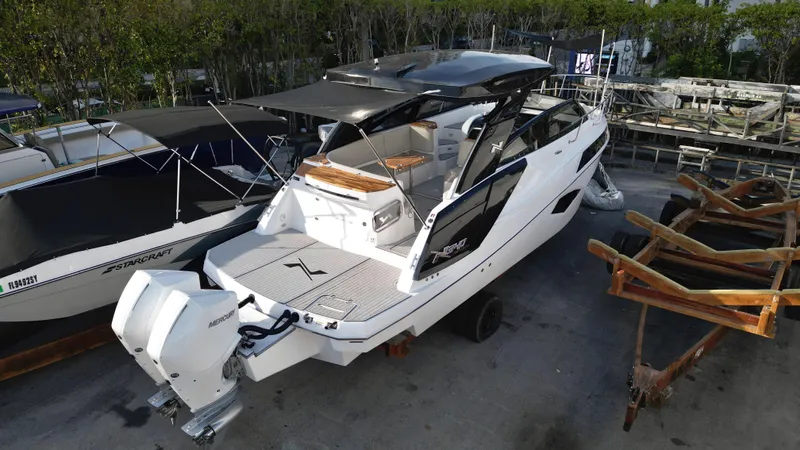  Yacht Photos Pics 2023 NX Boats 34 Sport Coupe, luxury motorboat docked, rear view.