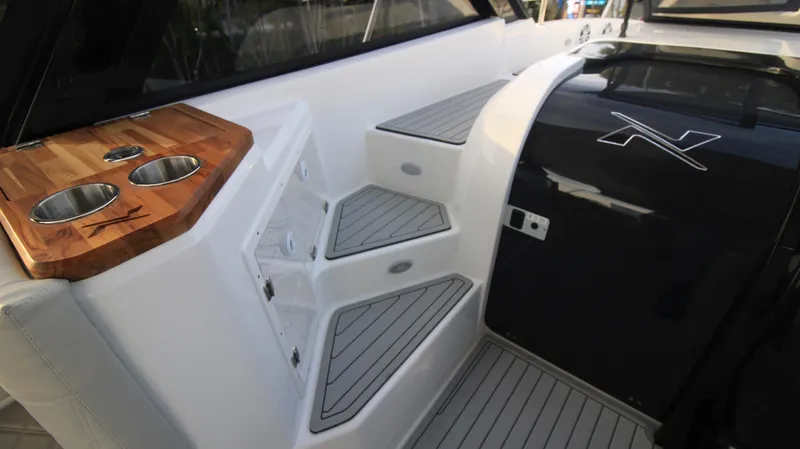 Yacht Photos Pics 2023 NX Boats 34 Sport Coupe interior with steps and cup holders.