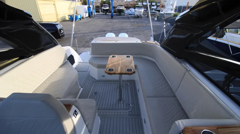  Yacht Photos Pics 2023 NX Boats 34 Sport Coupe interior with seating and table.