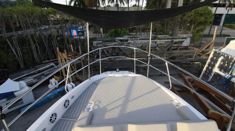  Yacht Photos Pics 2023 NX Boats 34 Sport Coupe, front deck view with sunshade and seating area.