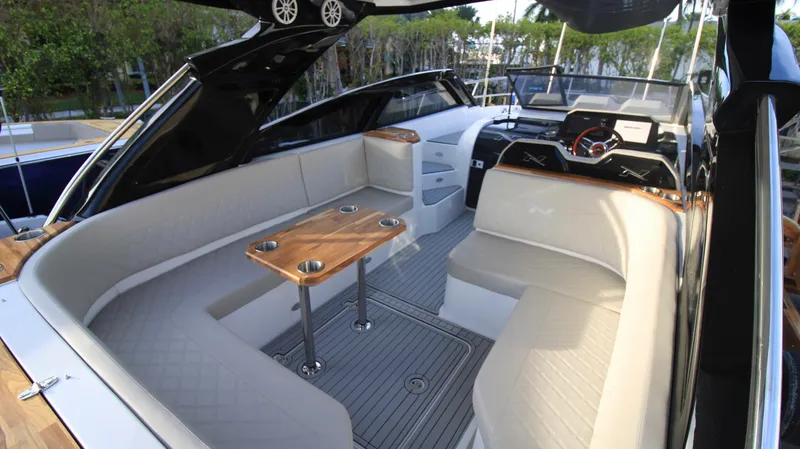  Yacht Photos Pics 2023 NX Boats 34 Sport Coupe interior with luxurious seating and wooden table.