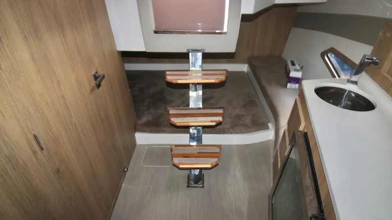  Yacht Photos Pics 2023 NX Boats 34 Sport Coupe interior cabin with wooden steps and modern amenities.