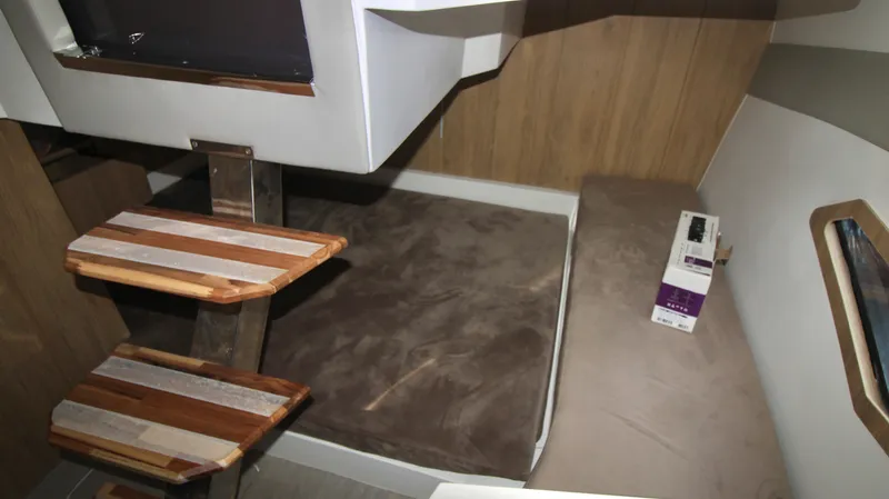  Yacht Photos Pics Interior cabin of 2023 NX Boats 34 Sport Coupe with wooden steps and cushioned seating.