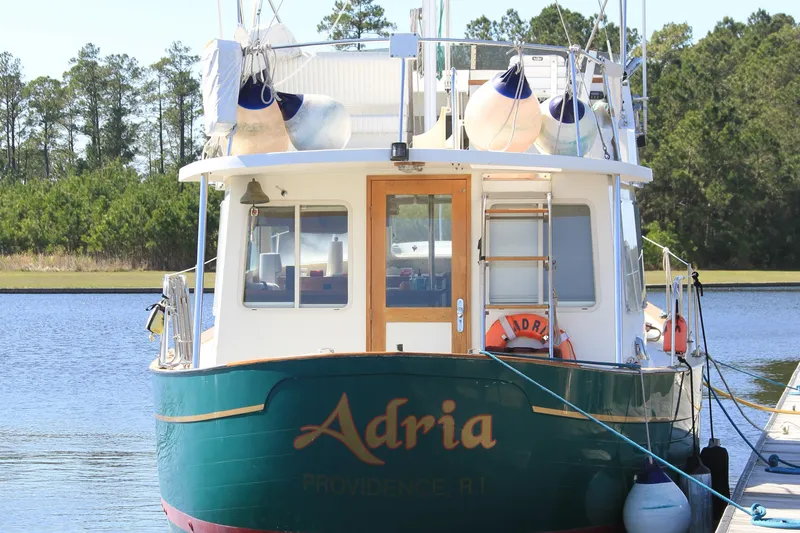Adria Yacht Photos Pics Willard Marine 40 Flybridge Sedan Trawler, 2000, docked on a serene lake.