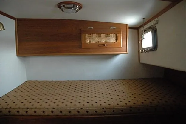 Adria Yacht Photos Pics Cozy cabin interior of 2000 Willard Marine 40 Flybridge Sedan Trawler with wooden accents.