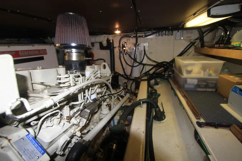 Adria Yacht Photos Pics Engine room of 2000 Willard Marine 40 Flybridge Sedan Trawler with visible generator and storage.