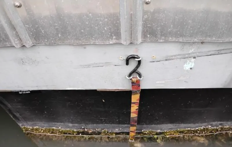  Yacht Photos Pics Close-up of a 2017 Custom Boathouse exterior with a hook and strap.