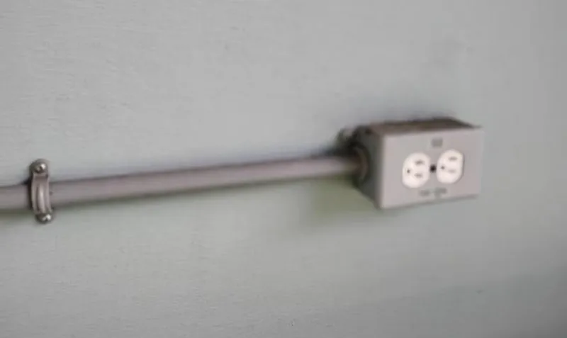  Yacht Photos Pics Electrical outlet with conduit on a light blue wall, Custom Boathouse, 2017.