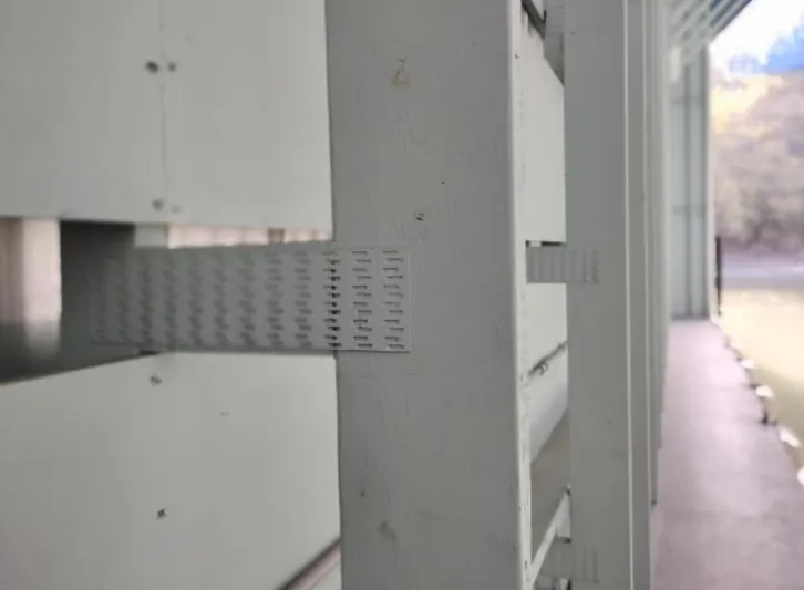  Yacht Photos Pics White wooden structure detail in a 2017 custom boathouse, featuring metal reinforcement.