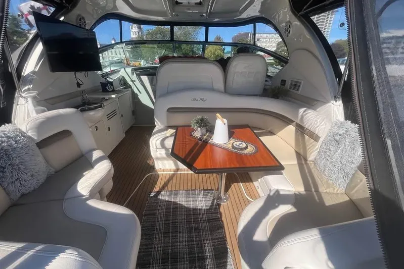  Yacht Photos Pics Luxurious interior of a 2012 Sea Ray 390 Sundancer yacht with plush seating and elegant decor.