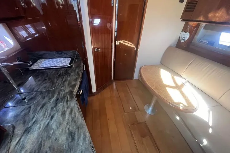  Yacht Photos Pics Luxurious interior of 2012 Sea Ray 390 Sundancer yacht with elegant seating and kitchenette.