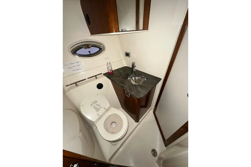  Yacht Photos Pics Bathroom interior of 2012 Sea Ray 390 Sundancer yacht with sink and toilet.