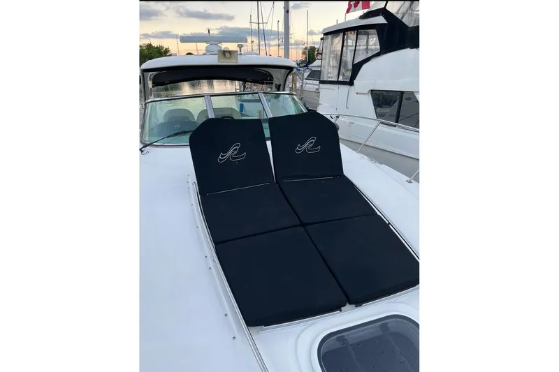  Yacht Photos Pics 2012 Sea Ray 390 Sundancer yacht with black sun pads on deck at sunset.