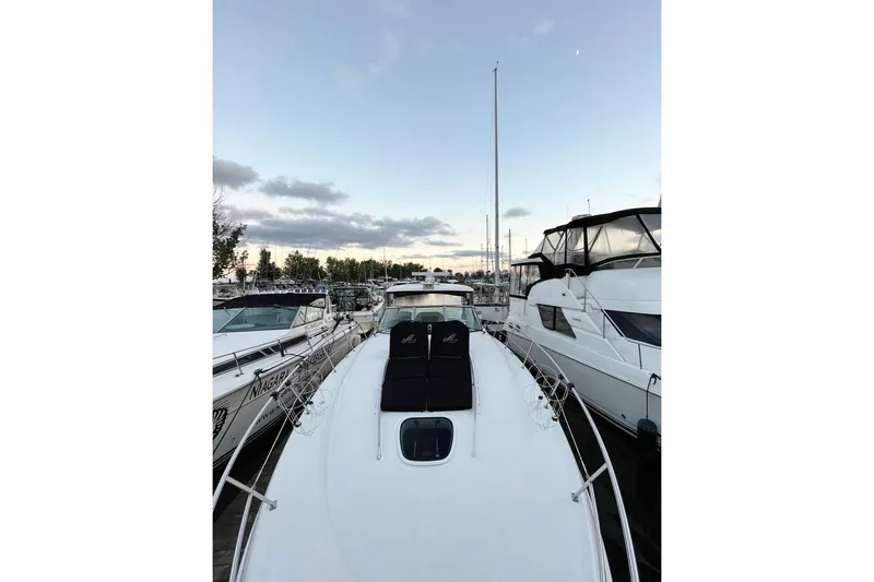  Yacht Photos Pics 2012 Sea Ray 390 Sundancer yacht docked at marina, surrounded by other boats.