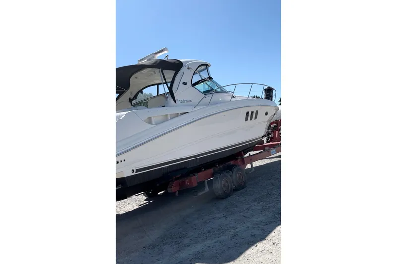  Yacht Photos Pics 2012 Sea Ray 390 Sundancer yacht on trailer under clear blue sky.