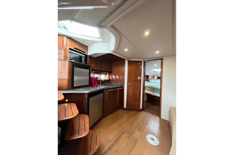  Yacht Photos Pics Luxurious interior of 2012 Sea Ray 390 Sundancer yacht with modern kitchen and cozy cabin.