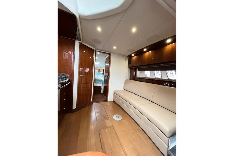  Yacht Photos Pics Luxurious interior of 2012 Sea Ray 390 Sundancer yacht with elegant seating and wood finishes.