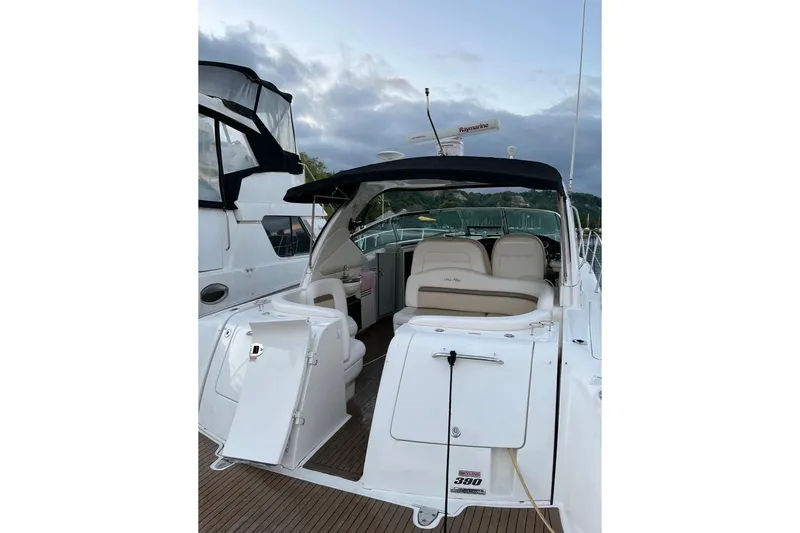  Yacht Photos Pics 2012 Sea Ray 390 Sundancer yacht with open cockpit, docked under cloudy skies.