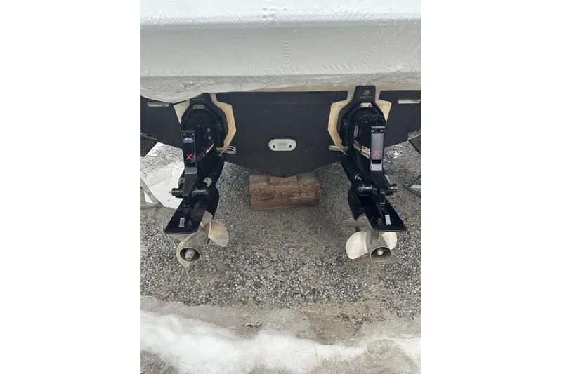  Yacht Photos Pics Twin propellers of a 2012 Sea Ray 390 Sundancer on gravel surface.