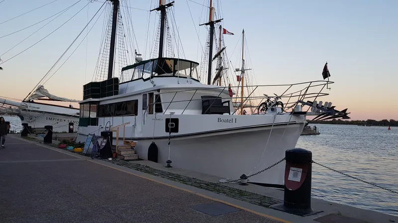 Boatel I Yacht Photos Pics Custom 65-foot trawler docked at sunset, 1998 model, with bicycles on deck.