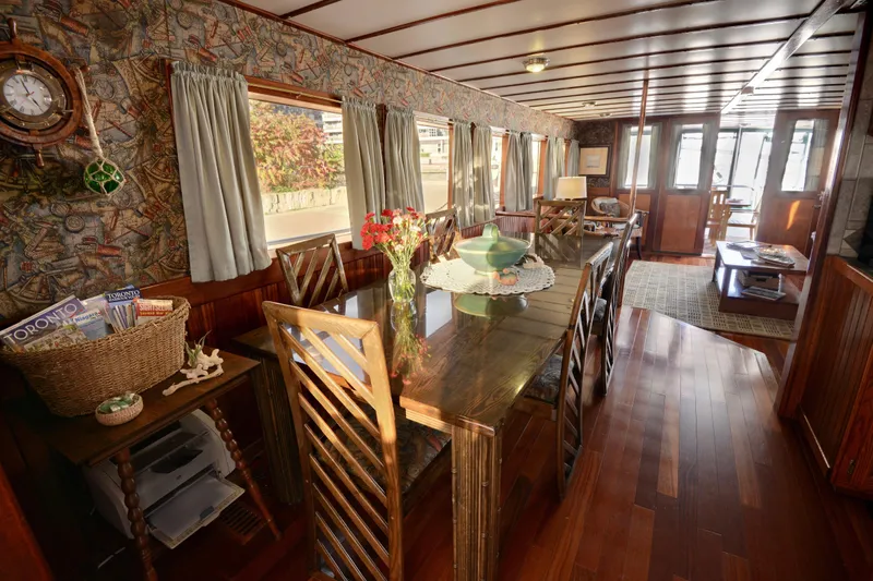 Boatel I Yacht Photos Pics Luxurious interior of a 1998 custom 65-foot trawler with elegant dining area and wooden decor.