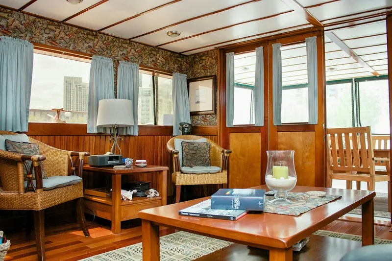 Boatel I Yacht Photos Pics Interior of a 1998 Custom 65 Foot Trawler with cozy seating and wooden decor.