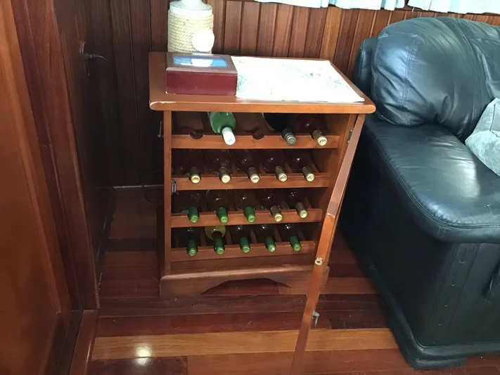 Boatel I Yacht Photos Pics Wine rack on a 1998 Custom 65 Foot Trawler, beside a leather sofa.