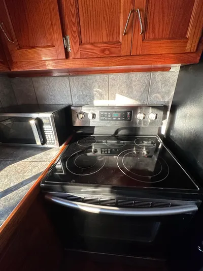 Boatel I Yacht Photos Pics Kitchen area in a 1998 Custom 65 Foot Trawler with stove and microwave.