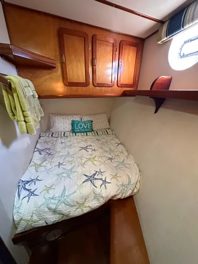 Boatel I Yacht Photos Pics Cozy cabin bedroom in a 1998 Custom 65 Foot Trawler with starfish-themed bedding.