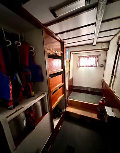 Boatel I Yacht Photos Pics Interior of a 1998 Custom 65 Foot Trawler with storage and life jackets.